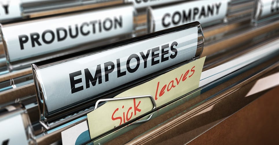 Close up on a file tab with the word employees plus a note with the text sick leaves, blur effect at the background. Concept image for illustration of sick leave entitlement.