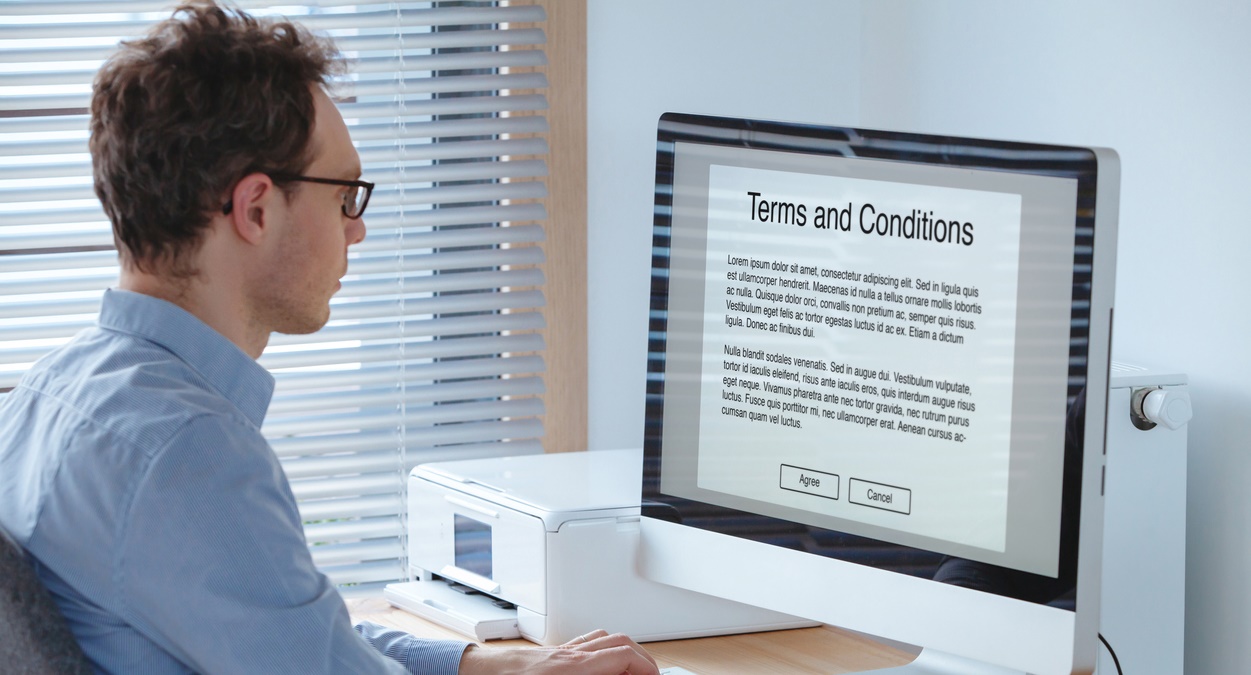 Terms of service, business man reading conditions on the screen of computer.